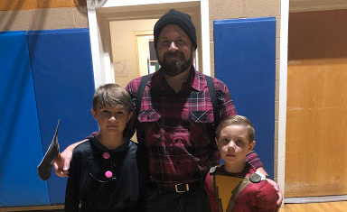 Director of Bands Andrew Jimeson (center) brought his children, Maddox and Ryland to the haunted trail event.