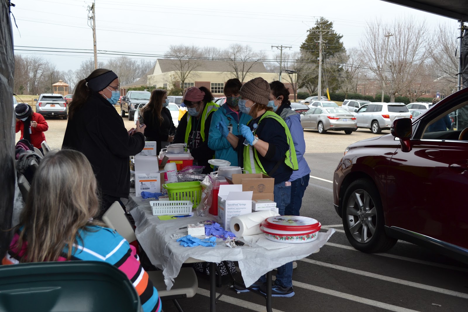 Health department employees and nurses administer a vaccine to a patient at the January 15 clinic.