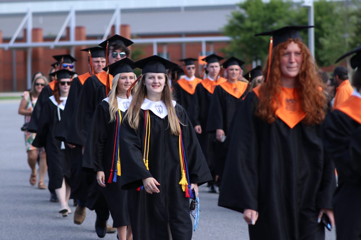 Davie High's seniors process to the football stadium for their commencement ceremony.