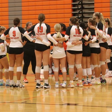 Coach Amber Brandon leads the volleyball team through their routine pep talk.