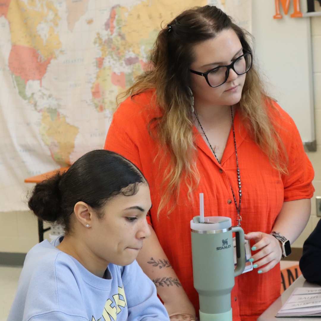 History teacher Kamryn Harris assists sophomore Nevasia Millsaps on an assignment.