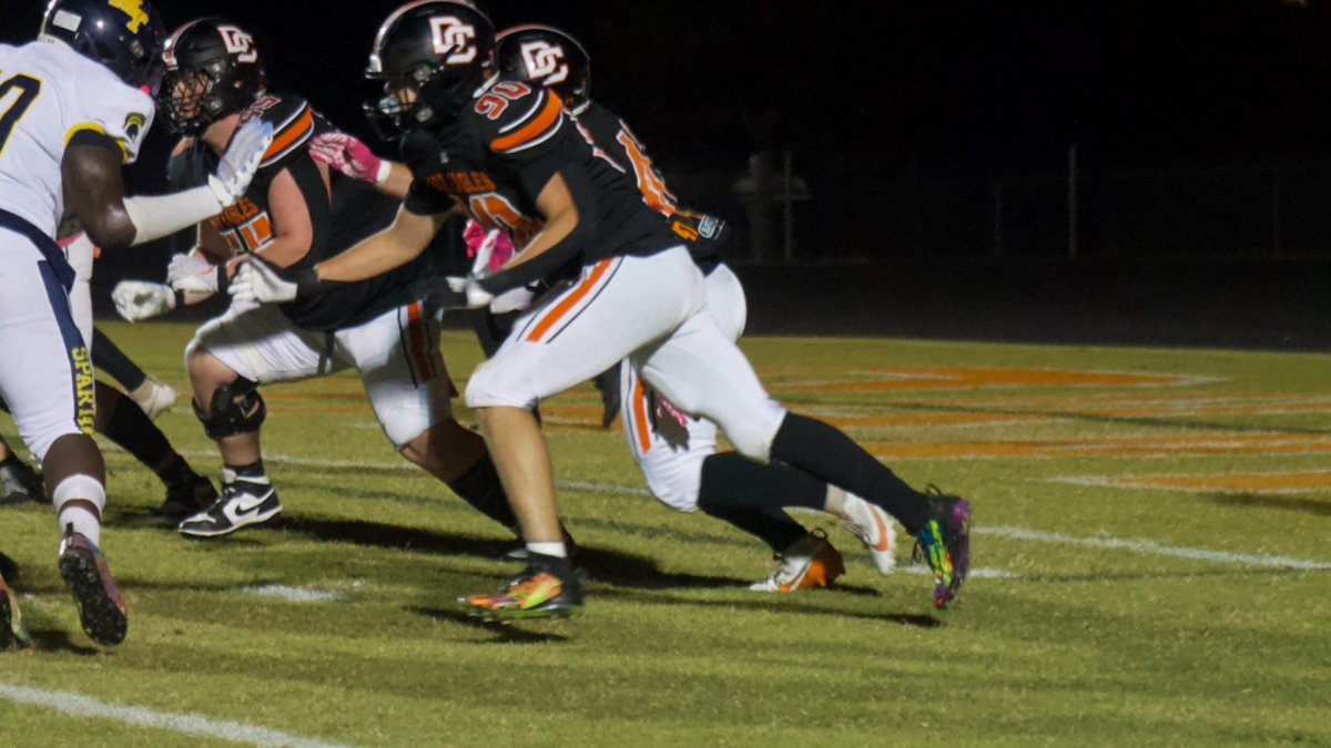 Davie football players execute a play during their matchup against Mt. Tabor.