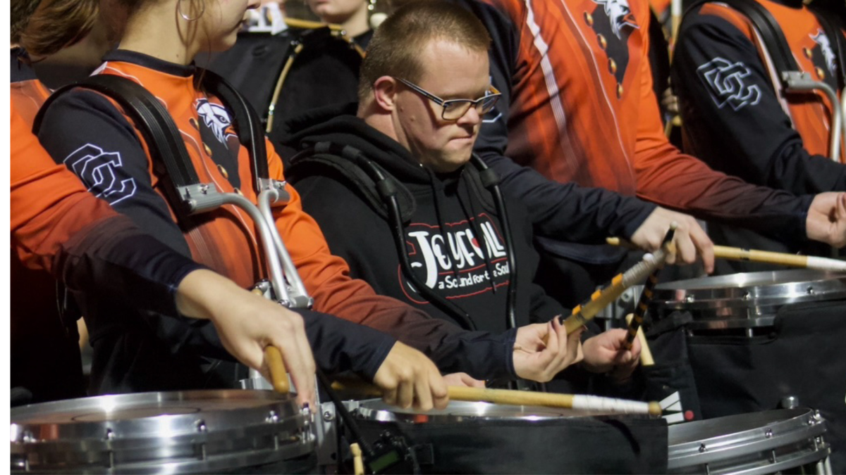 Members of the Joyful-A Sound Band play with the drumline during halftime.