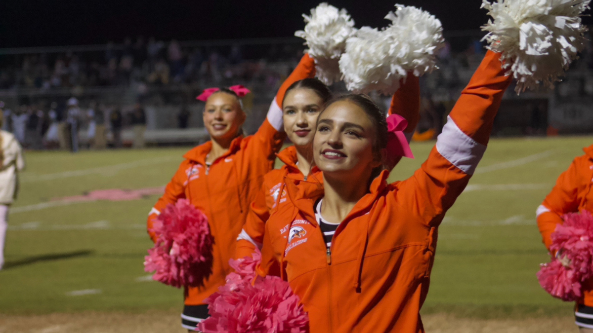 Cheerleaders pump up the crowd on the sidelines.