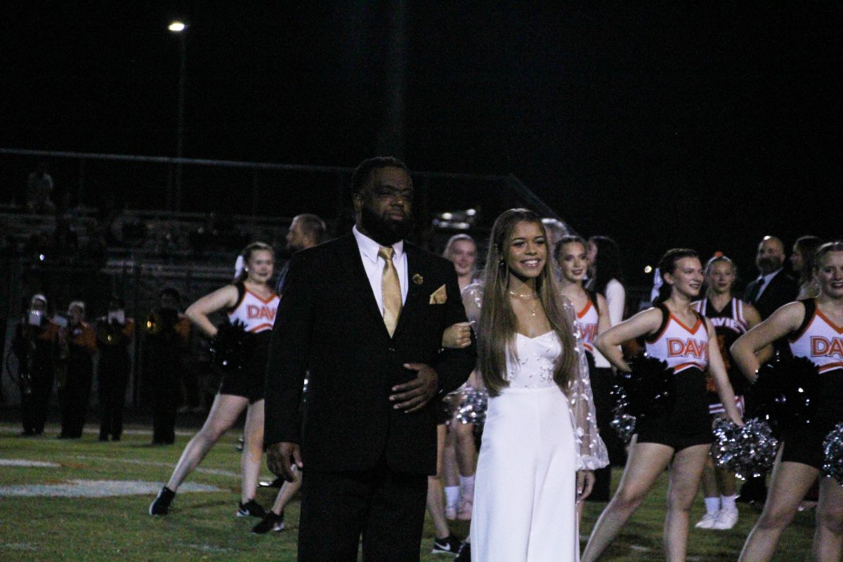 Kaylee Lewis is escorted by her father, Marnic Lewis, before being announced as fourth runner-up.