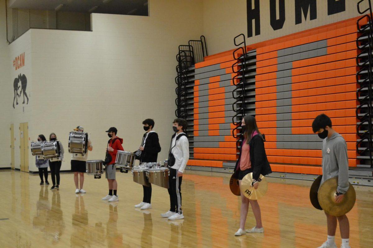 The drumline watches as the King and Court are announced.