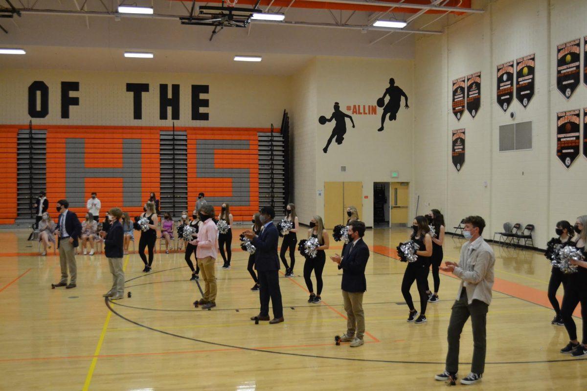 Other nominees for Homecoming King and the Dancing Boots cheer on the winners.