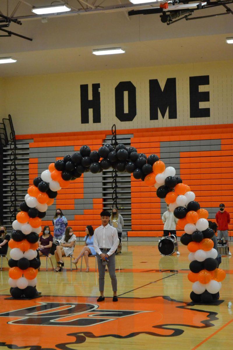 Xander Youmans was 1st runner-up. The drumline and Homecoming Queen nominees watch from behind.