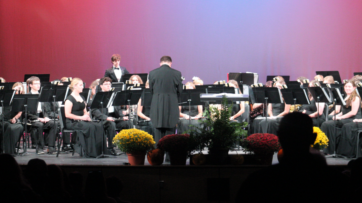 The band awaits director Matthew Brusseau's instruction to begin their performance.