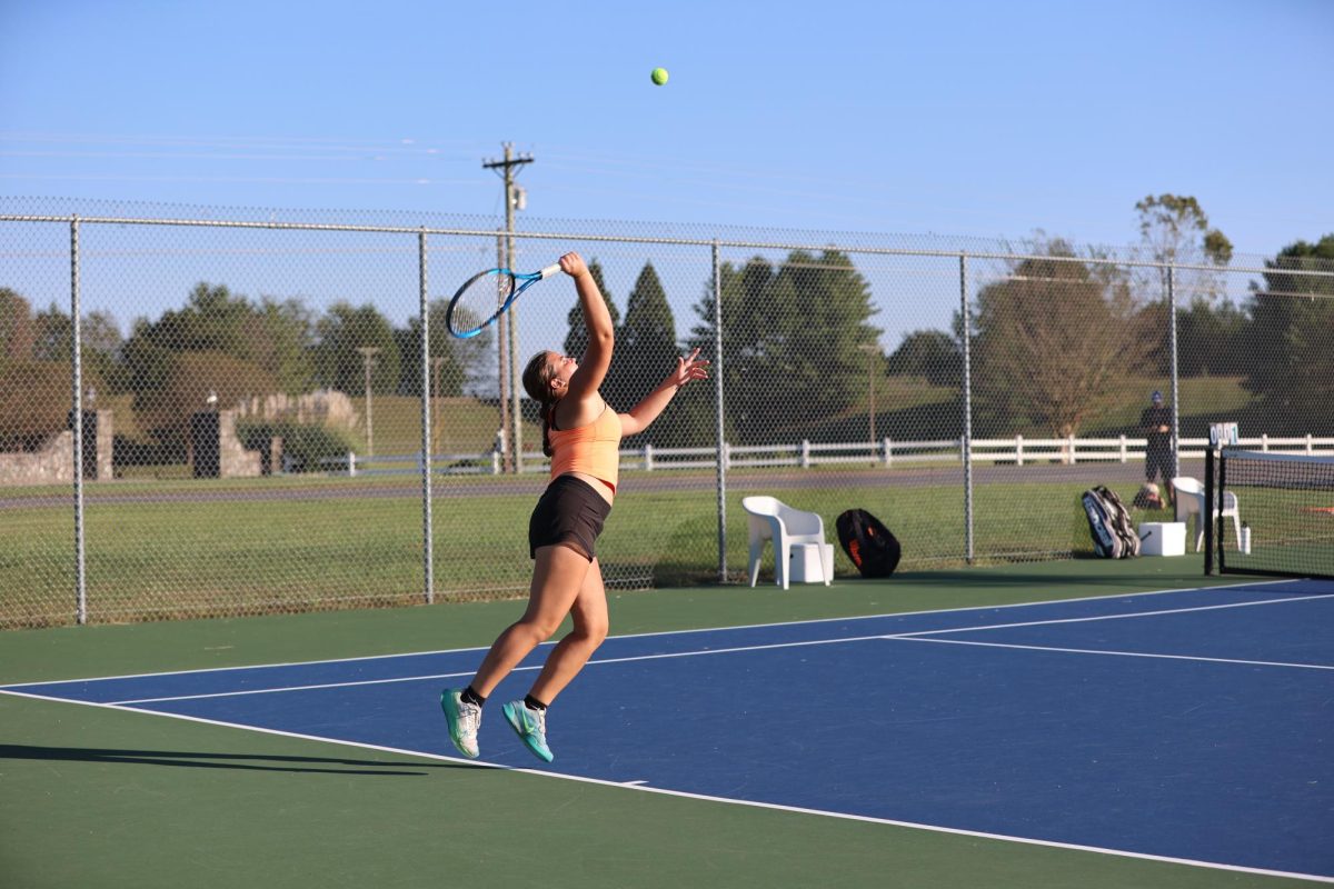 Elliot Newsome lines up for a serve at a home match.