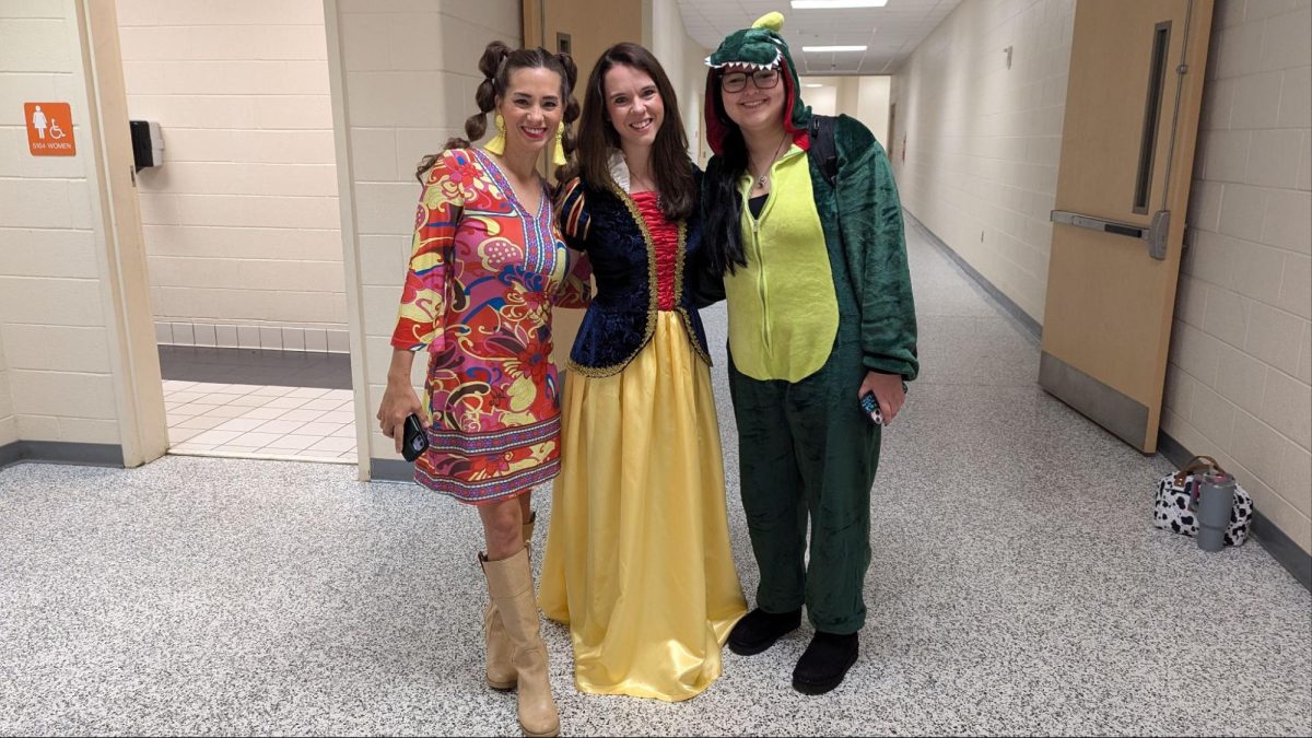 From left to right Teachers Sarah Davis, Brittany Darst, and senior Cheyenne Clemmons show off their costumes for this Halloween. 