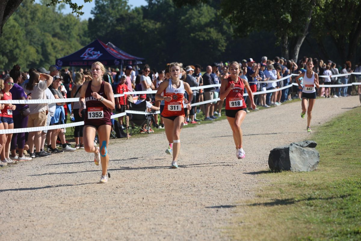 Junior Lexi Marion races down the straightaway toward the finish line at the Providence XC Invitational.