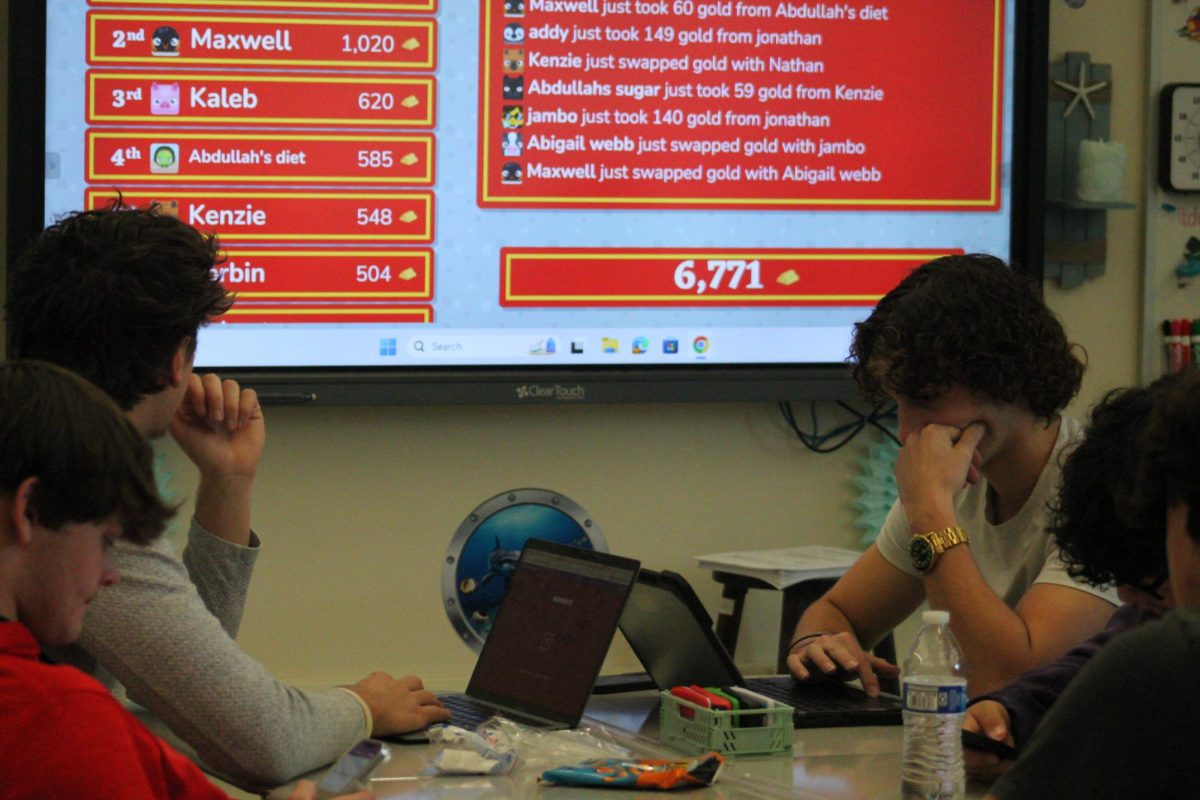 Senior Logan Tronsen and other members of the Stock Market Club participate in a simulation at their meeting on Monday, December 2.