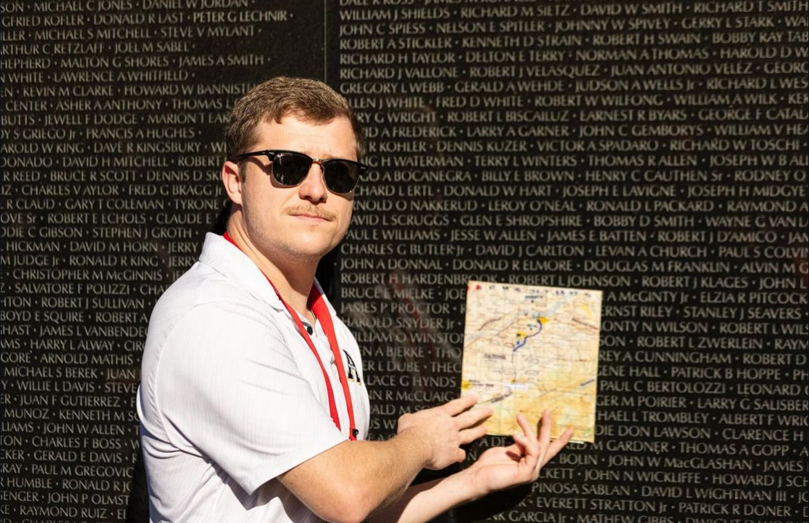 Zach Wood poses in front of the Vietnam Veterans Memorial in Washington, D.C.