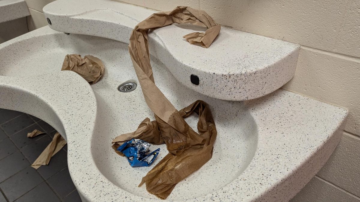 Paper towels and assorted trash sit in a sink in a Davie High bathroom after class change.