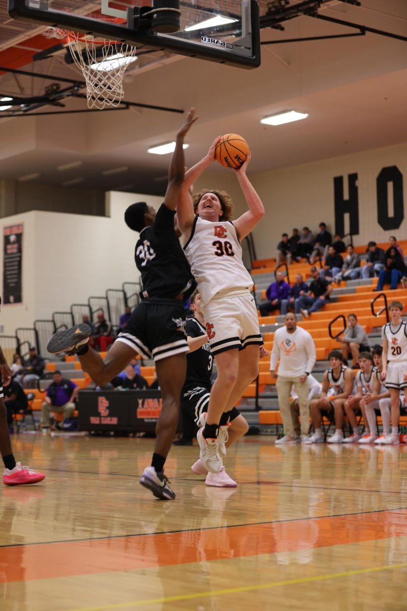 Jackson Powers collides with the defender as he goes in for the shot. 