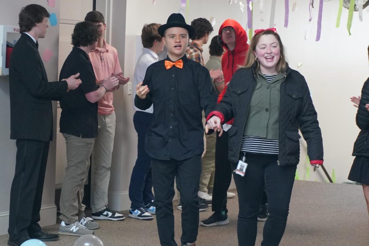 Gigi Burgiss escorts Brody Ward through a tunnel of NHS students into the sanctuary of First Baptist Church, Mocksville, for the annual Hope Prom.