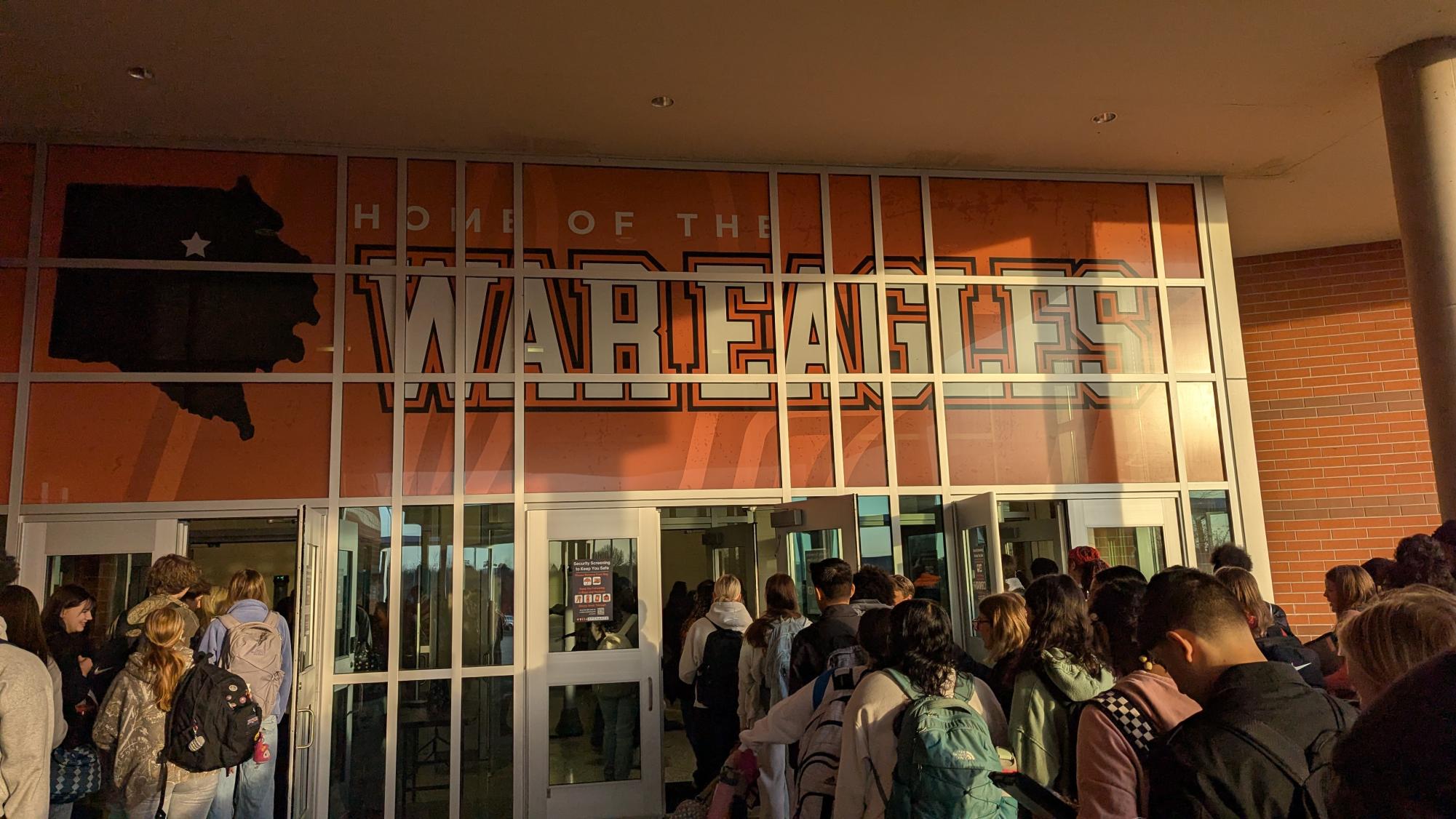 Students stand in line on the morning of February 5 waiting to walk through the new Open Gate metal detectors on the first day of their implementation.