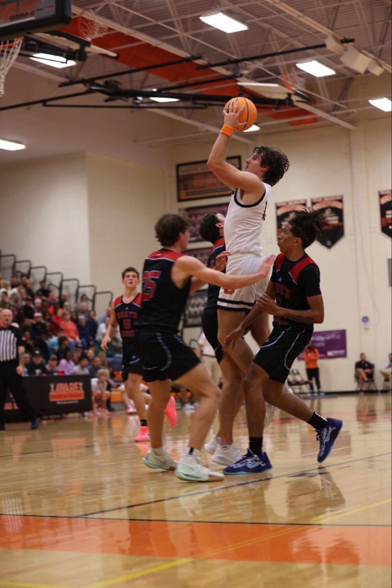 Senior, Elliot Erlandsson goes up for a tough shot against three defenders.