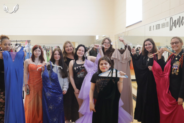 Davie students pose along with English teacher Erica Spry with their chosen prom dresses at the second annual prom pop-up shop organized by Davie's Travel Club.