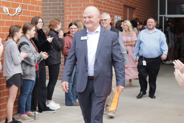 Superintendent Jeff Wallace exits Davie High on his final official walkthrough of campus before his retirement. Students applauded Wallace as he left the building on the morning of April 14.