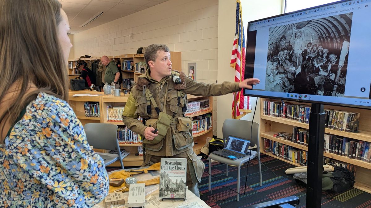 History teacher Zach Wood wears a highly detailed replica of what a paratrooper of the 101st Airborne Division would have jumped into Normandy with on June 6, 1944. Wood chose to portray a rifleman from the paratroops to bring history to life. His goal is to make the pictures larger than life and make it seem like he stepped out of a Time Machine from June 1944.