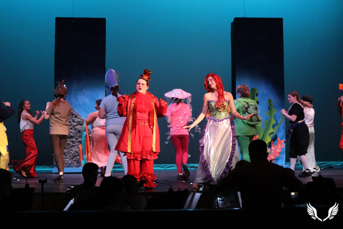 (Left to Right) Senior Cora Nicholson and sophomore Keara Dowd (Sebastian and Ariel) perform "Under the Sea" during Davie High's production of "The Little Mermaid."