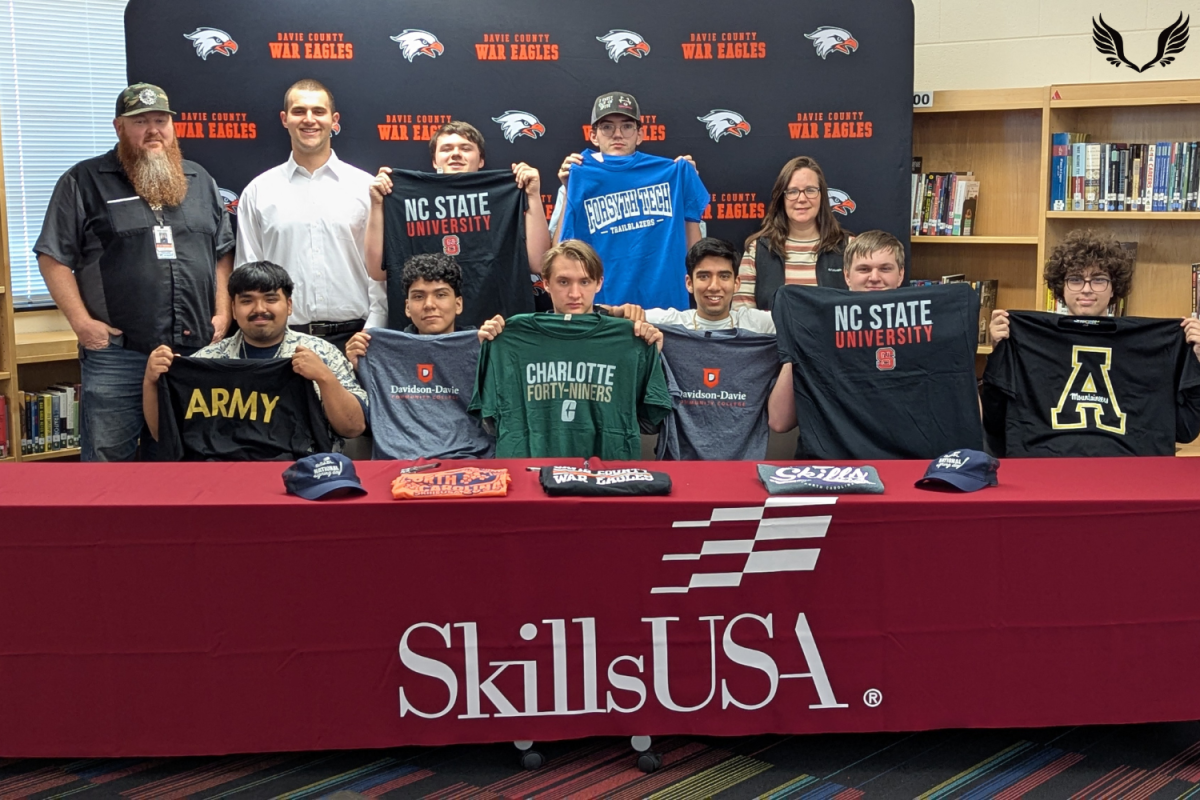 SkillsUSA seniors pose with advisors Seth James and Angela Reeves at the first SkillsUSA Signing Day at Davie High