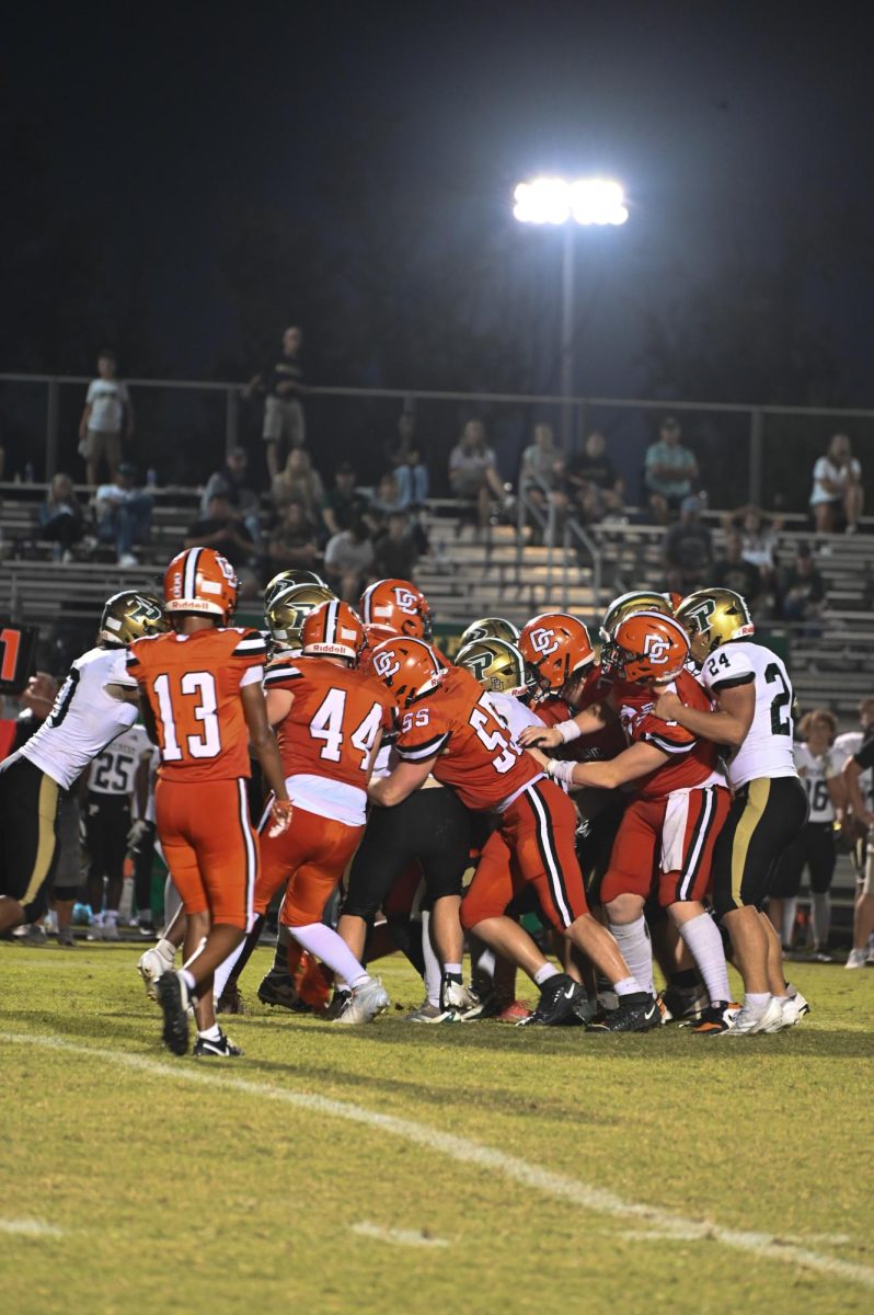 Maddox Creason, Kaleb Bales, and Christian Collins are on offense trying to protect the ball from Pinecrest.