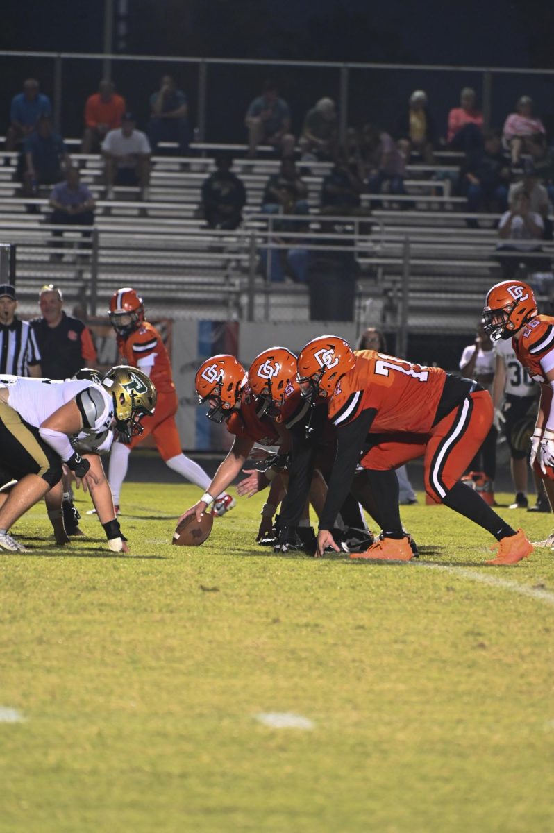 Christian Collins, Xzvavier Parker, and Evan Helms get ready for offense while Ryan Williams snaps the ball to the quarterback. 