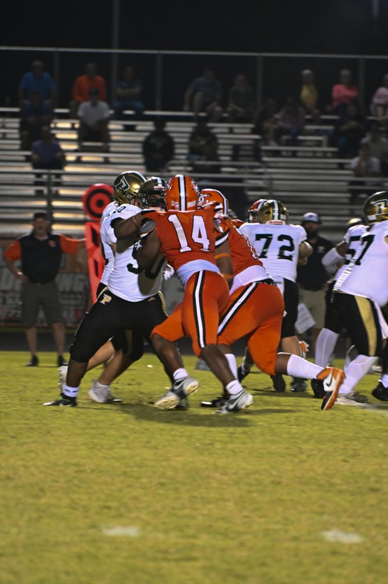 Jsiere Arnold is on defense trying to stop Pinecrest from advancing down the field.
