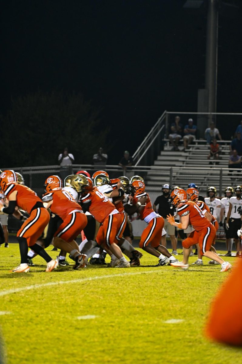 Austin Heath, Connor Dixon, Carson Perk, Jsiere Arnold, Elliot Gould, and Dylan Miller line up on a defensive line to get the ball back from Pinecrest.