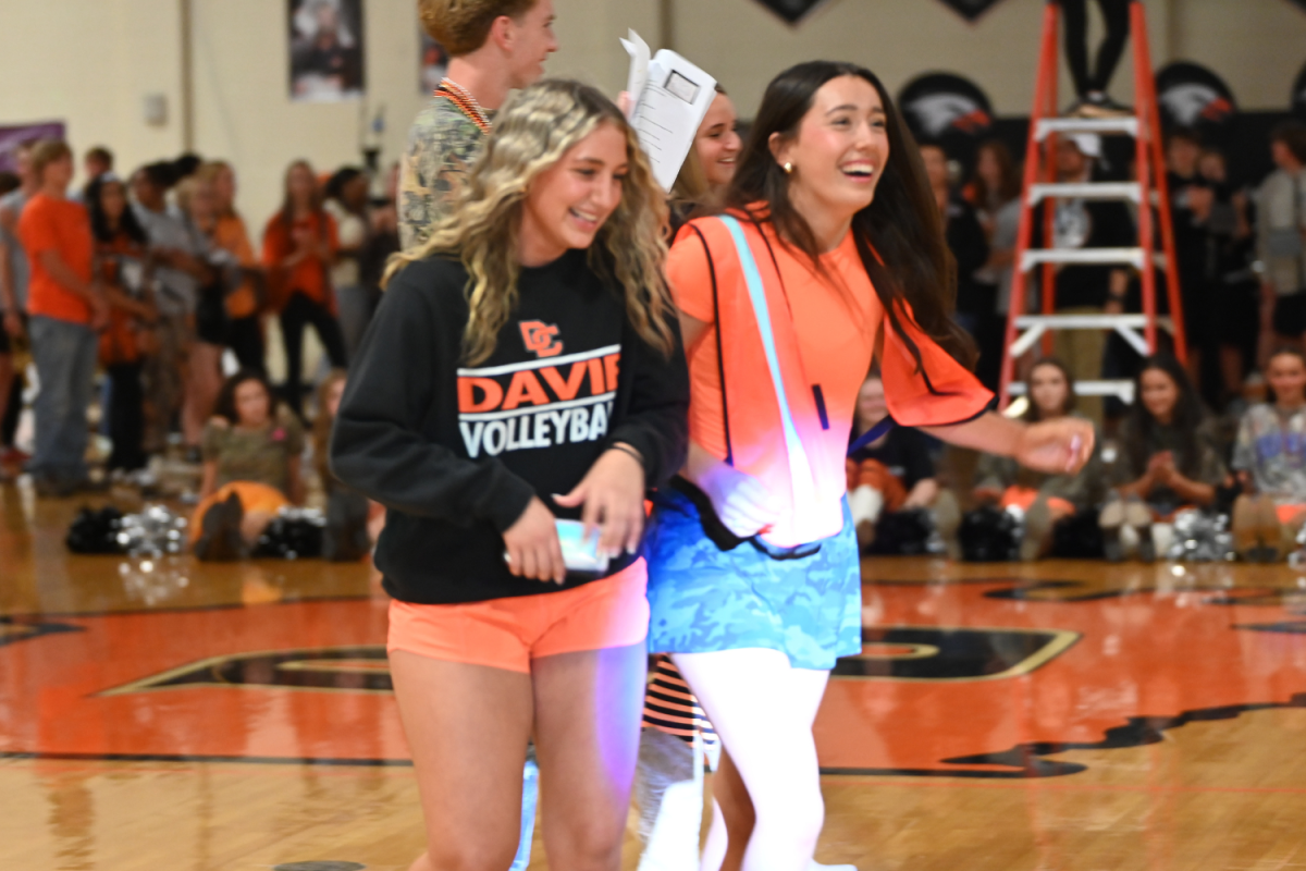 Juniors Ella Shea and Britt Carrier walk to center court as representatives of Davie’s volleyball team.