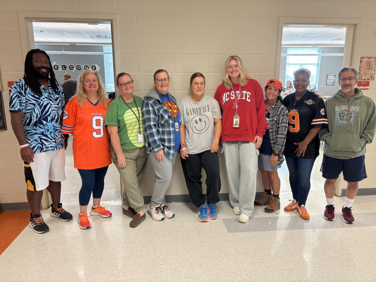 The math department poses together in their outfits, mainly baggy clothing and tennis shoes making them look like their students.