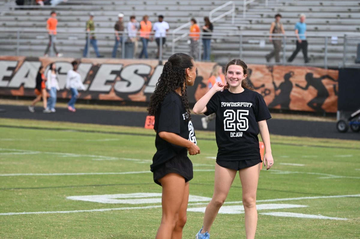 Black Team members celebrate between drives at the Powder Puff Football Game