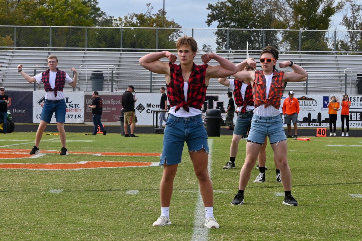 The Mancing Boots strike a pose at the end of their routine at halftime during the Powder Puff Football Game.