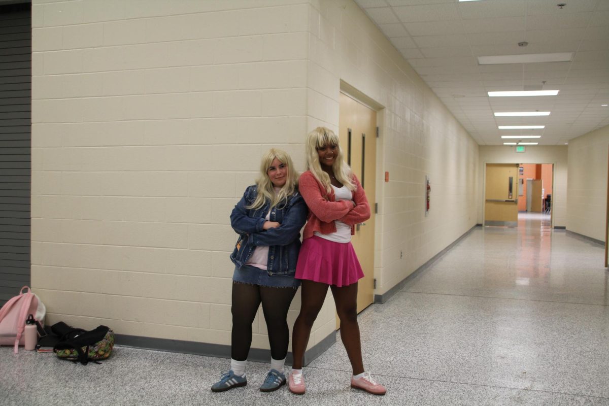 Seniors Natalie Laird and Yasmine Chambers pose in the arts hallway in their best “White Chicks” costumes.