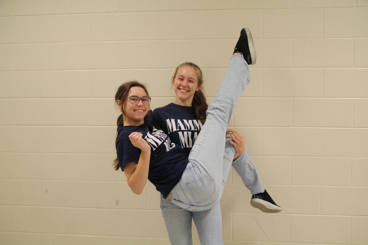  Senior Abby Clairmont and Junior Raina Calhoun match in their Mama Mia shirts and blue jeans, matching also with Chad Edwards.