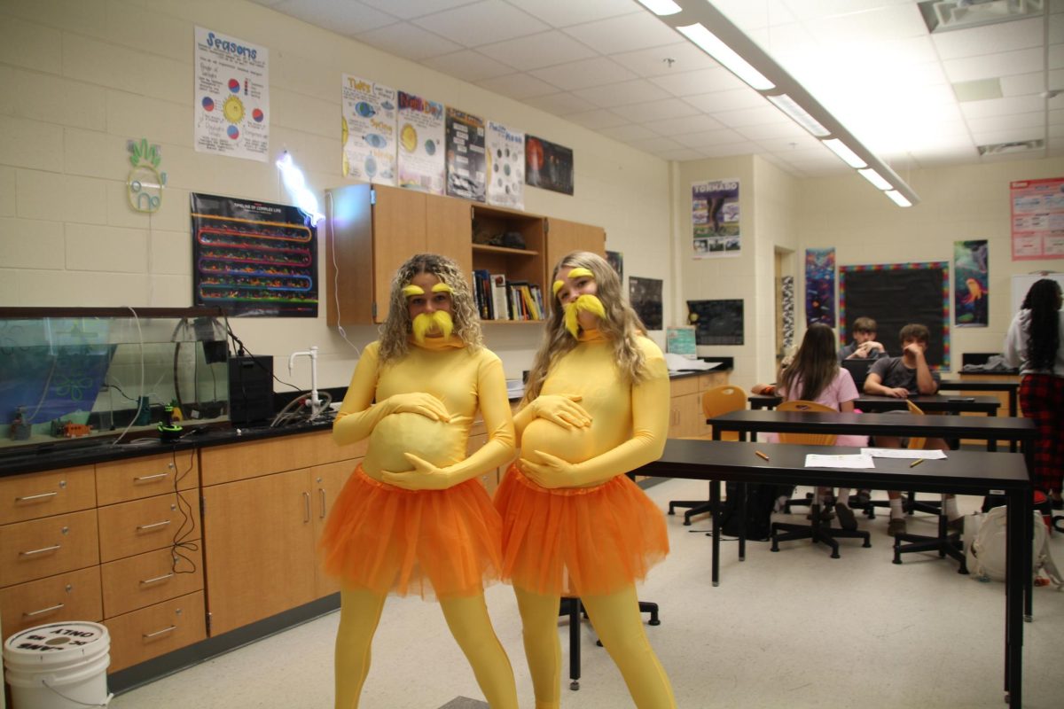 Freshman Summer Jones and her friend dressed as The Lorax are seen rubbing their fake bellies, playing into their costumes well.
