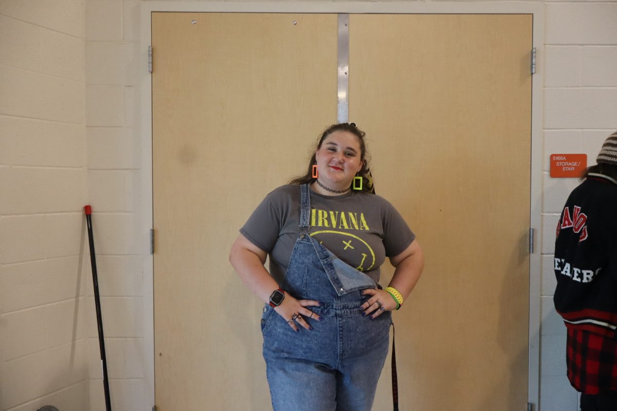  Junior Hailey Livengood is dressed in her best 90s outfit sporting a Nirvana shirt, overalls, and neon accessories.