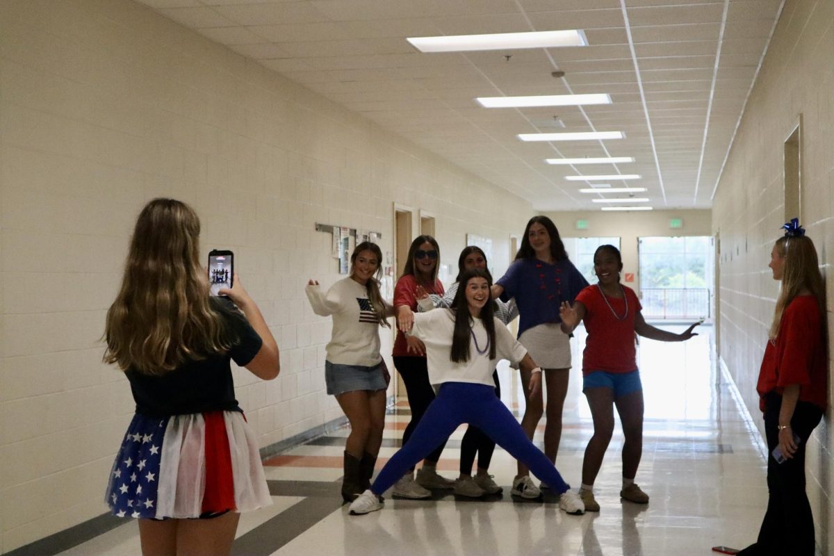Junior Hayden Smith is seen taking a video of a group of girls for the USA Day Tik Tok. 