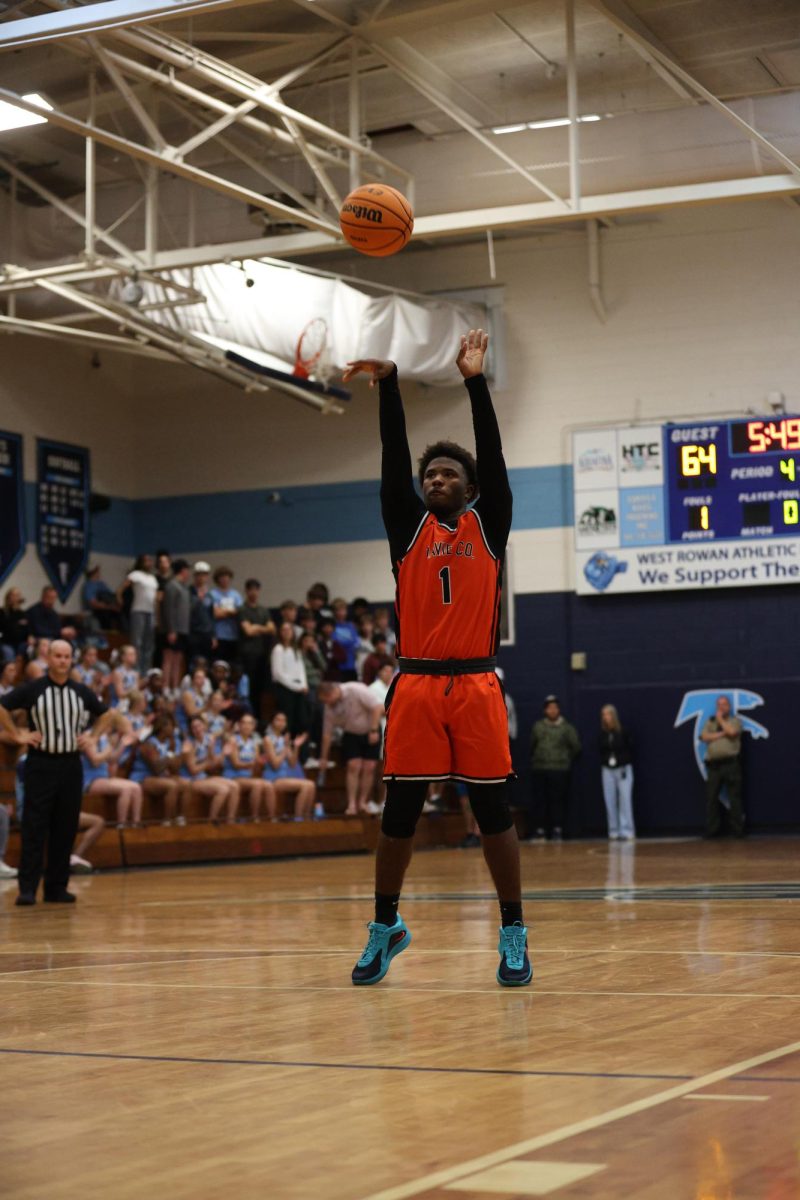 Launching the ball into the hoop, sophomore Draeton Nance is at the free-throw line. 