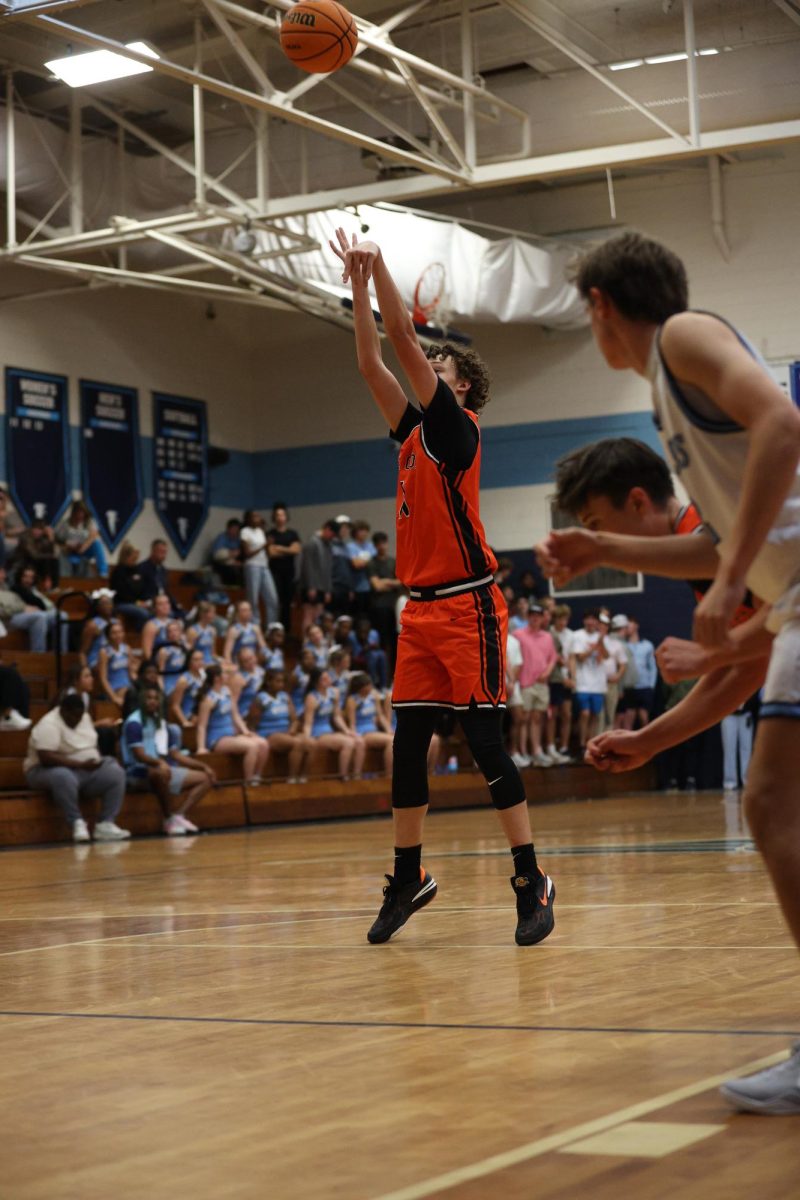 After getting fouled on, junior Aiden Horton lines up at the free-throw line, prepared to make the shot.