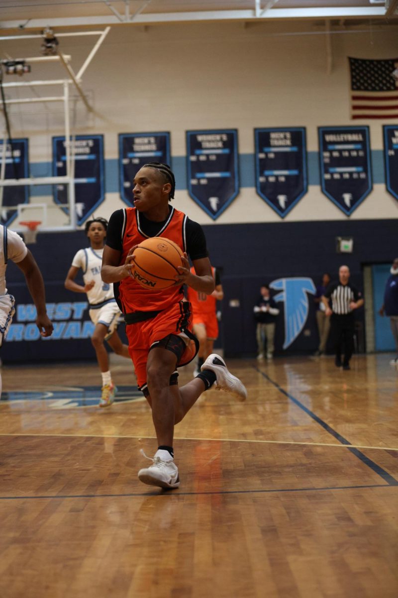 Sophomore Cameron Knox runs the ball down the court and is ready to make the layup.