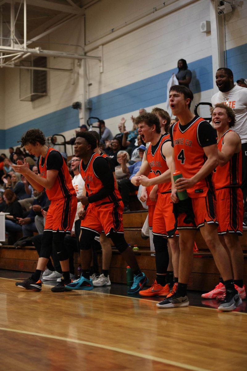 The War Eagles Men's Basketball Team stands to their feet after scoring a point against the West Rowan Falcons.
