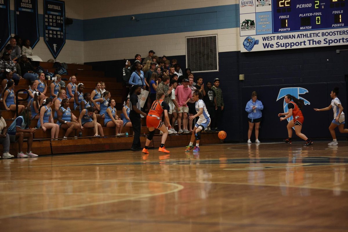 Following the play, sophomore Leah Burleyson passes the ball to Junior Maddison Daughterty to make the next shot.