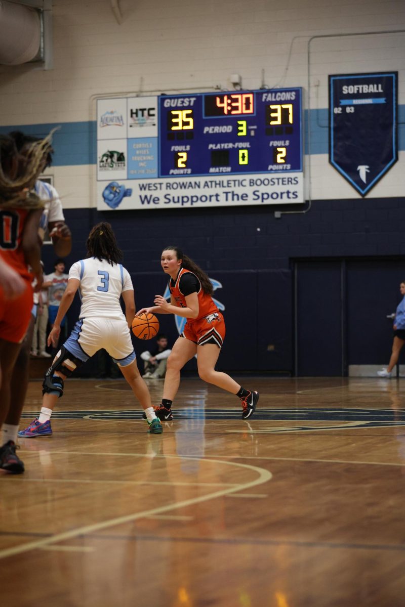 Ready to make the play, Junior Madison Daughterty dribbles the ball setting to make the pass.