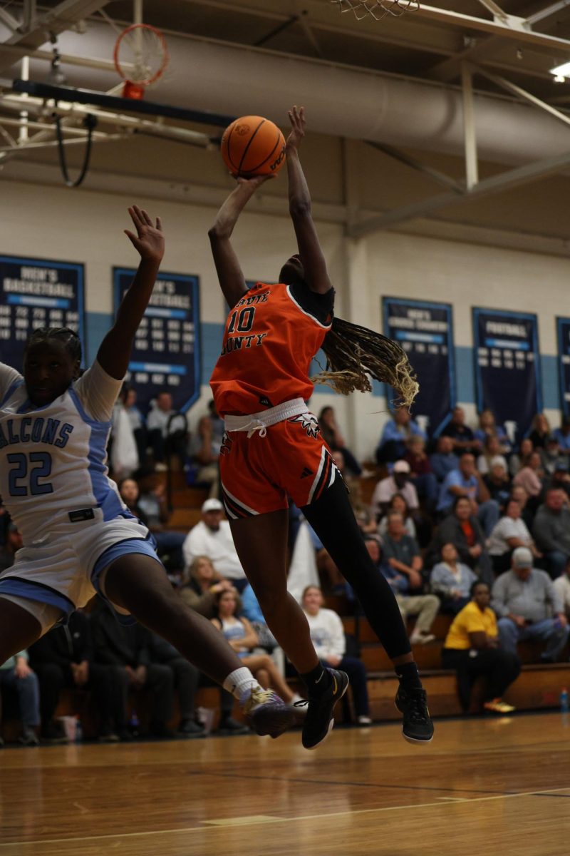Bouncing above the defense, junior Vivian Vaughters rises to make her shot.