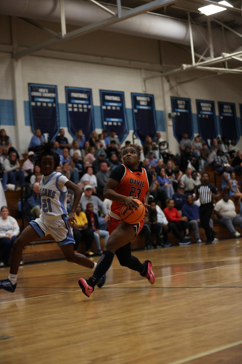 Bolting down the court, senior Makenzie Gentry prepares for the layup.