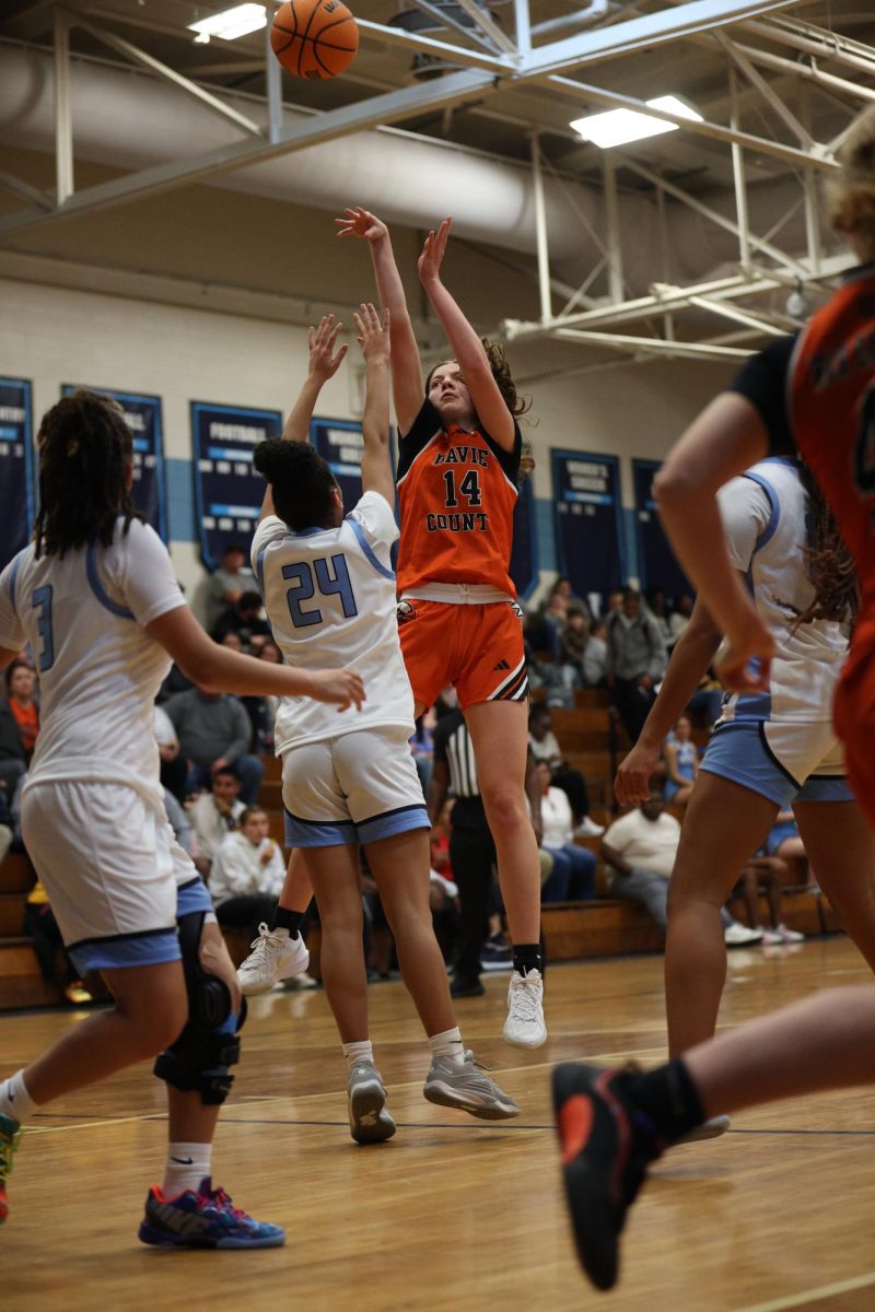 Finding her path, sophomore Olivia Smith takes the shot while the defense tries to block her. 